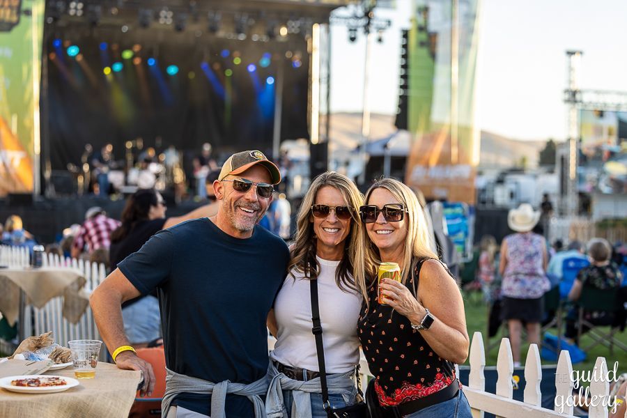 A group of people are posing for a picture at a concert.