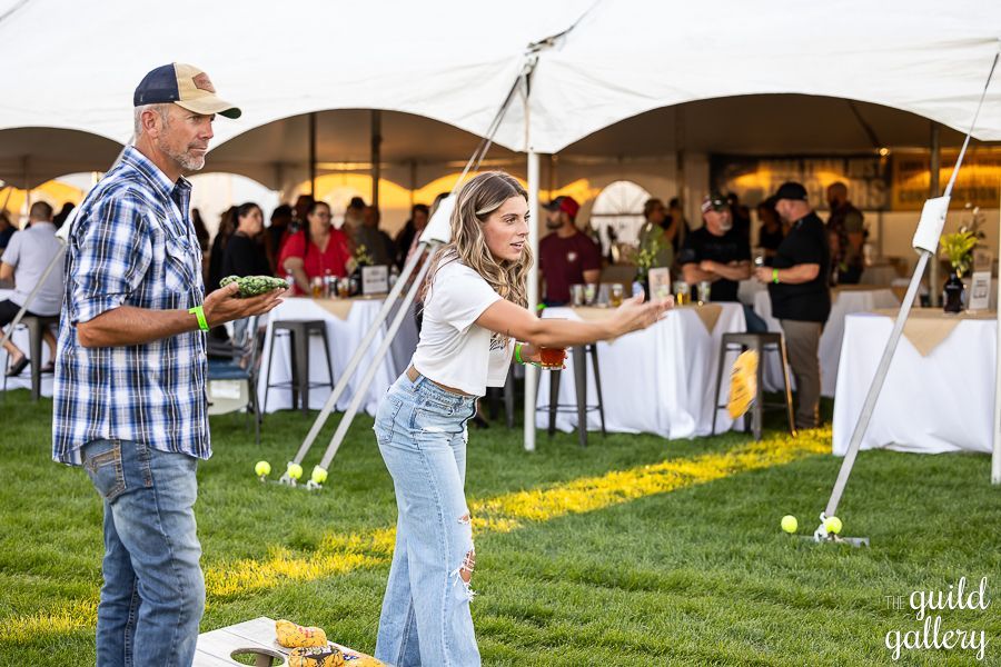 A man and a woman are playing a game in a field.