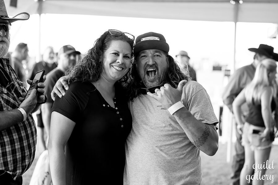 A man and a woman are posing for a picture in a black and white photo.
