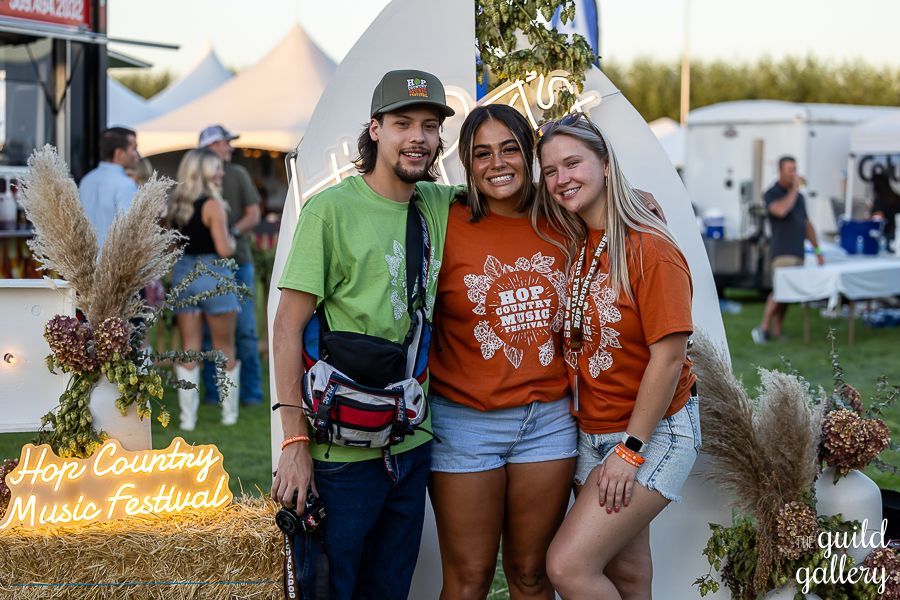 A group of people are posing for a picture at a music festival.