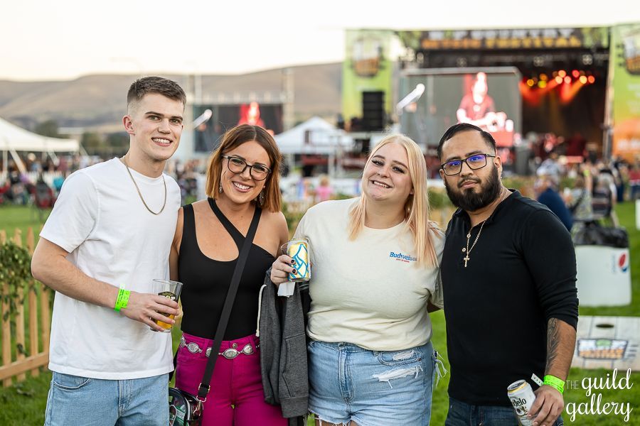 A group of people are posing for a picture at a concert.