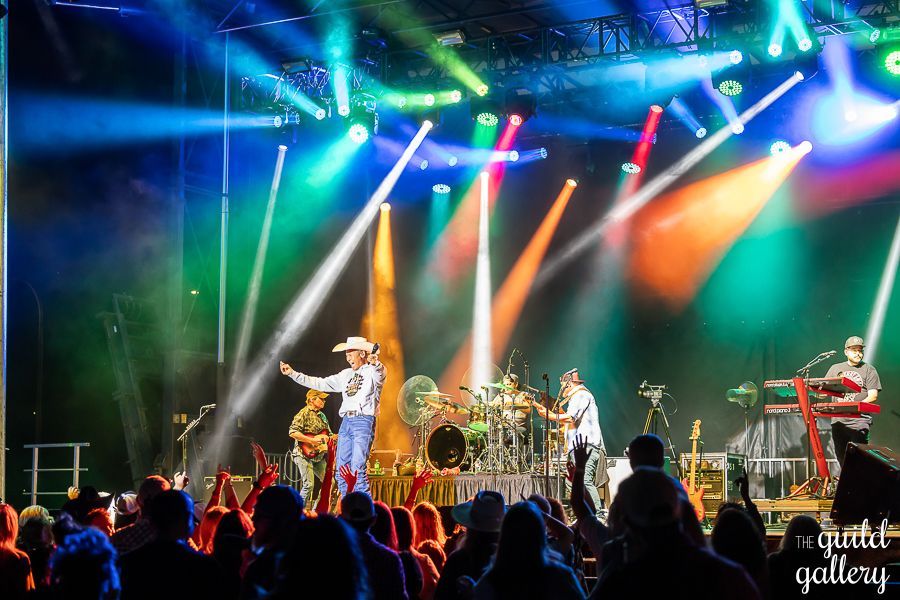 A group of people are standing on a stage in front of a crowd.