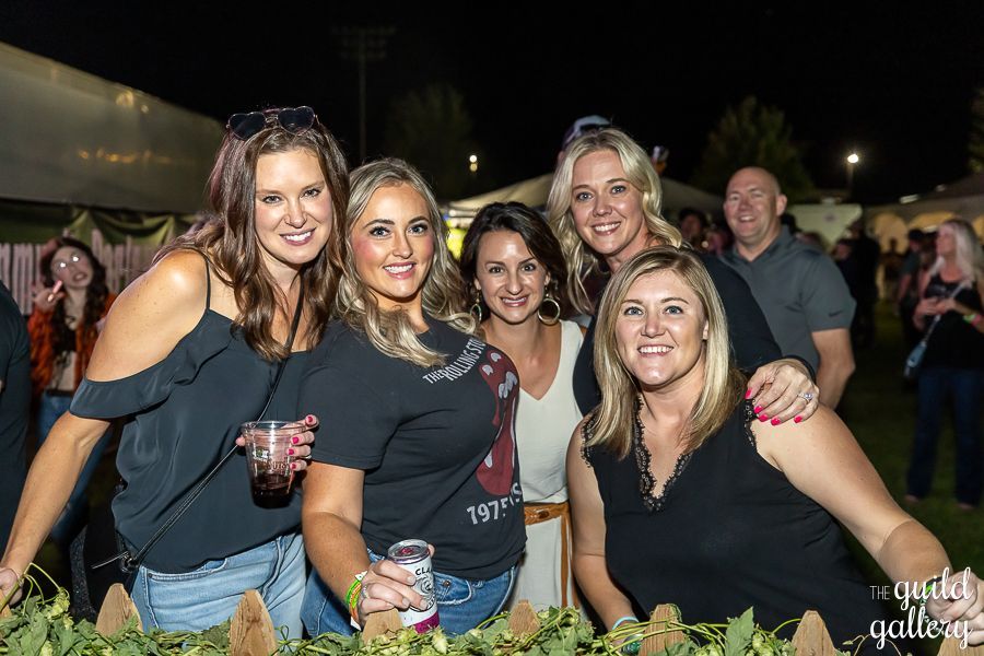 A group of women are posing for a picture at a party.