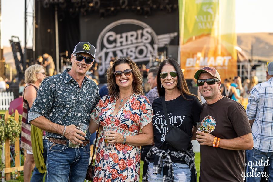 A group of people are posing for a picture at a concert.