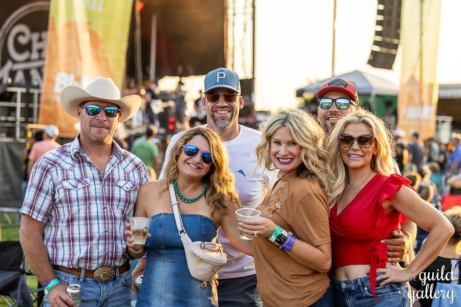 A group of people are posing for a picture at a concert.