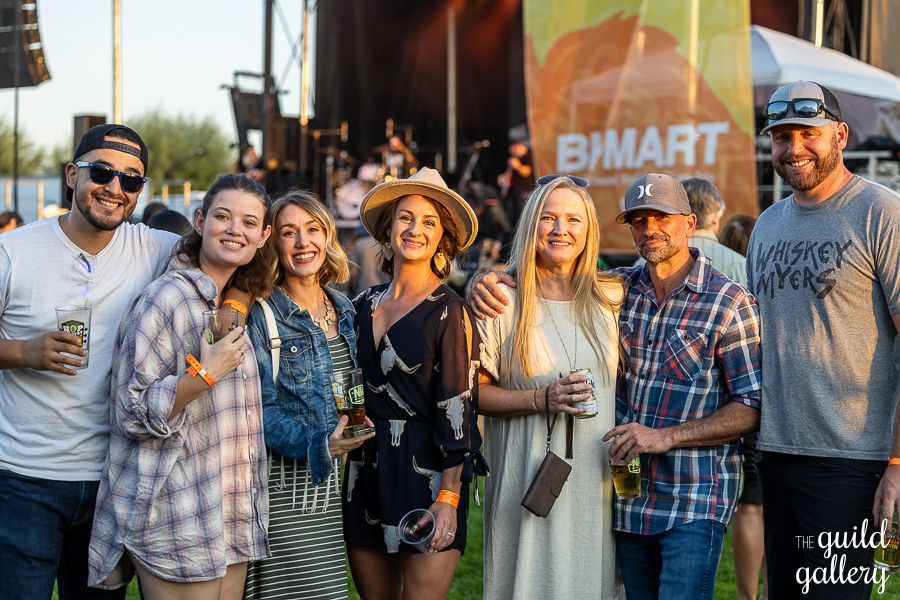 A group of people are posing for a picture at a concert.