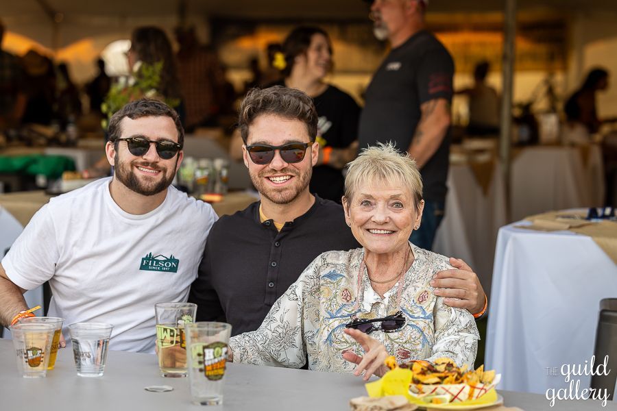 A group of people are posing for a picture at a table.