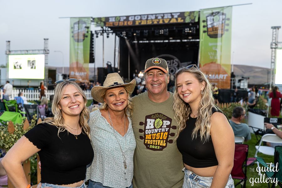 A family is posing for a picture at a concert.