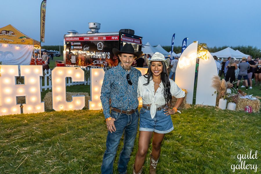 A man and a woman are standing next to each other in a field.