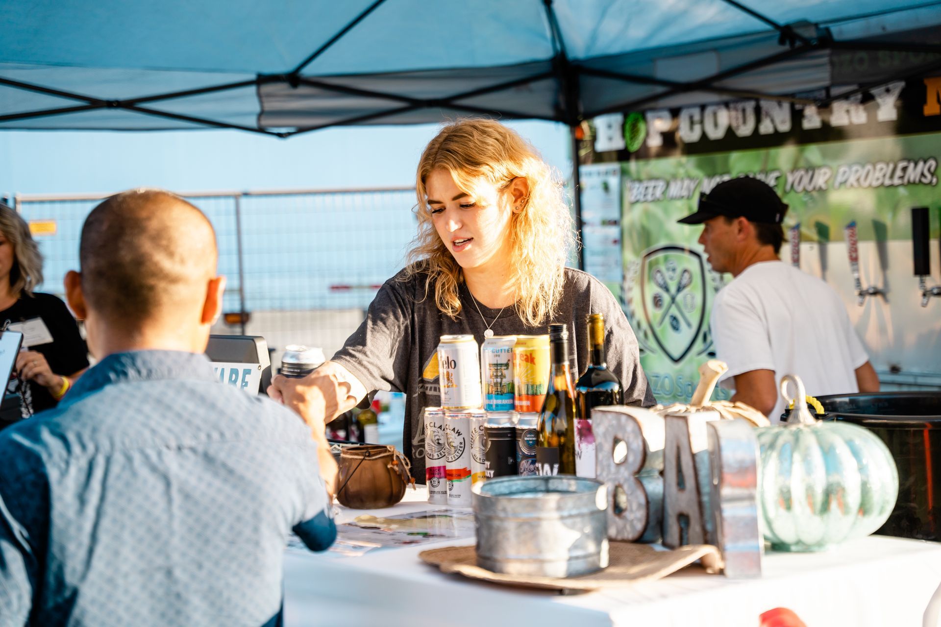A woman is sitting at a table talking to a man.