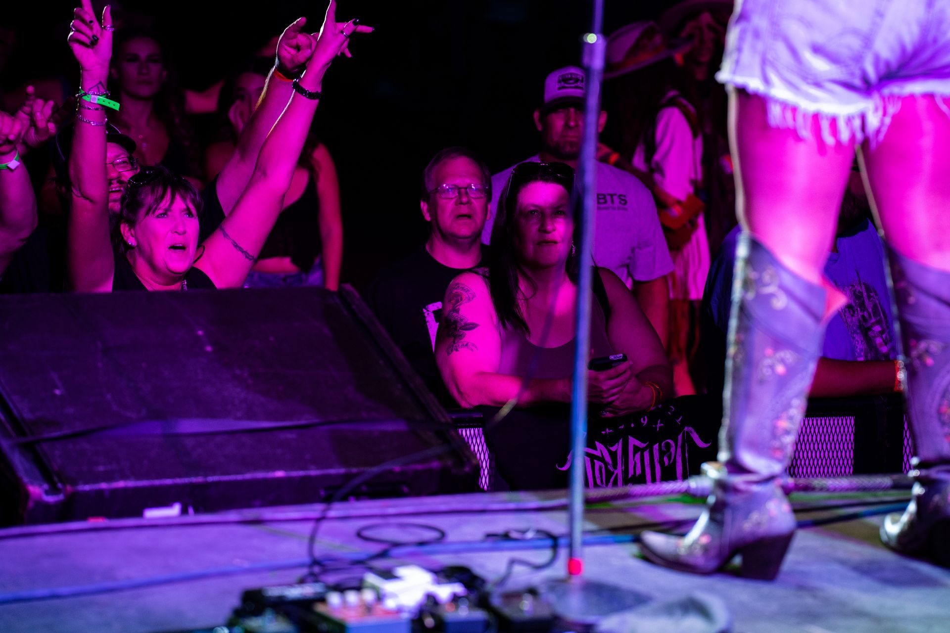 A woman is standing on a stage in front of a crowd of people.