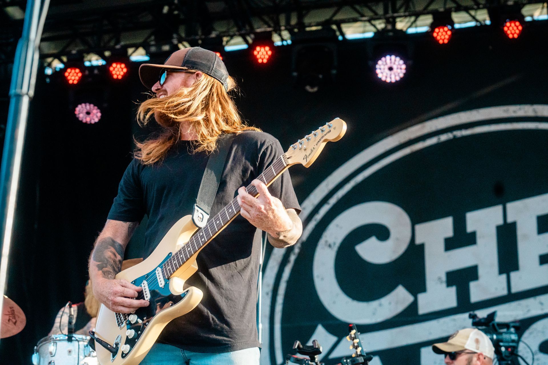 A man is playing a guitar on a stage.