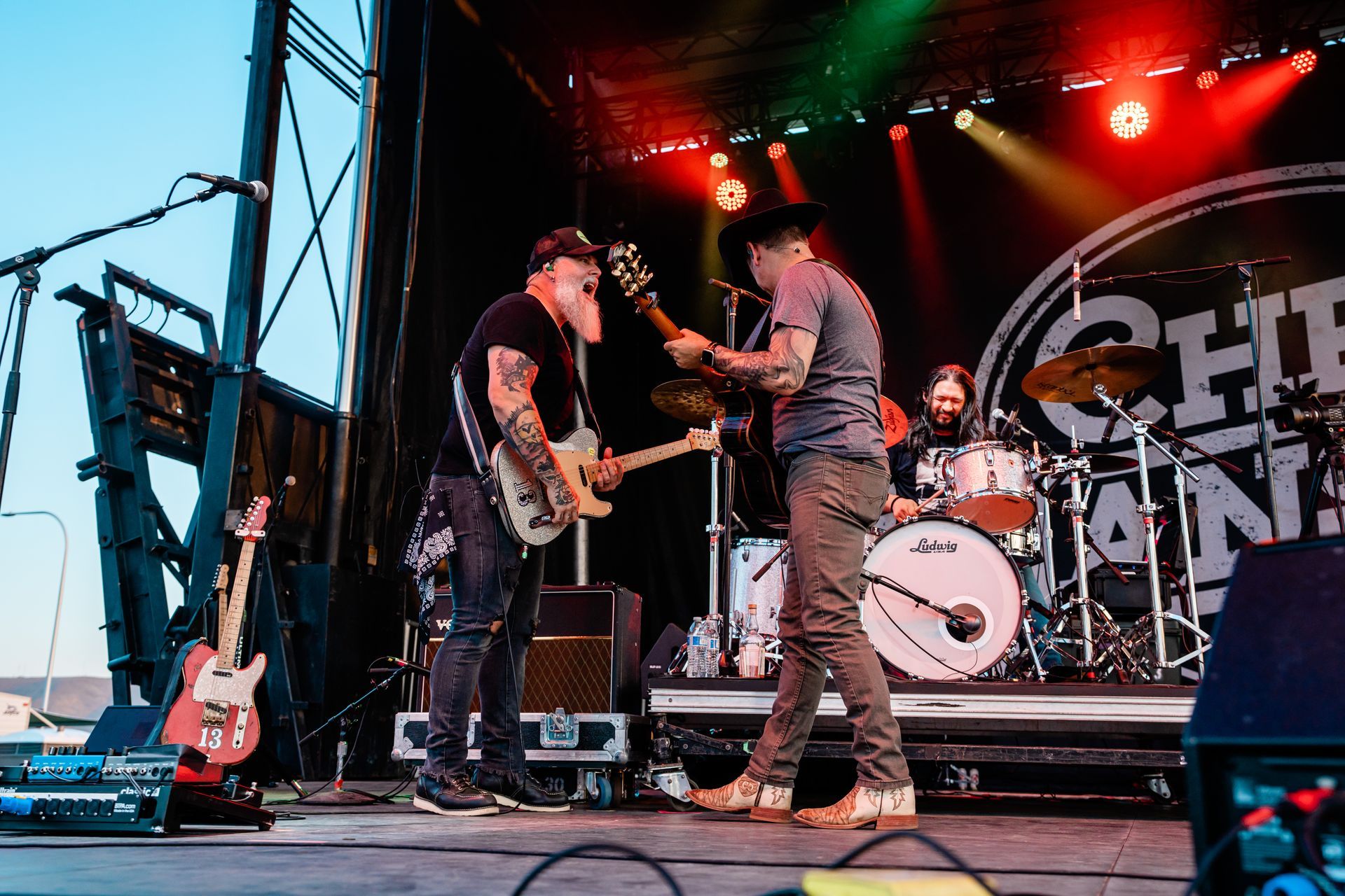 A group of men are playing guitars on a stage.