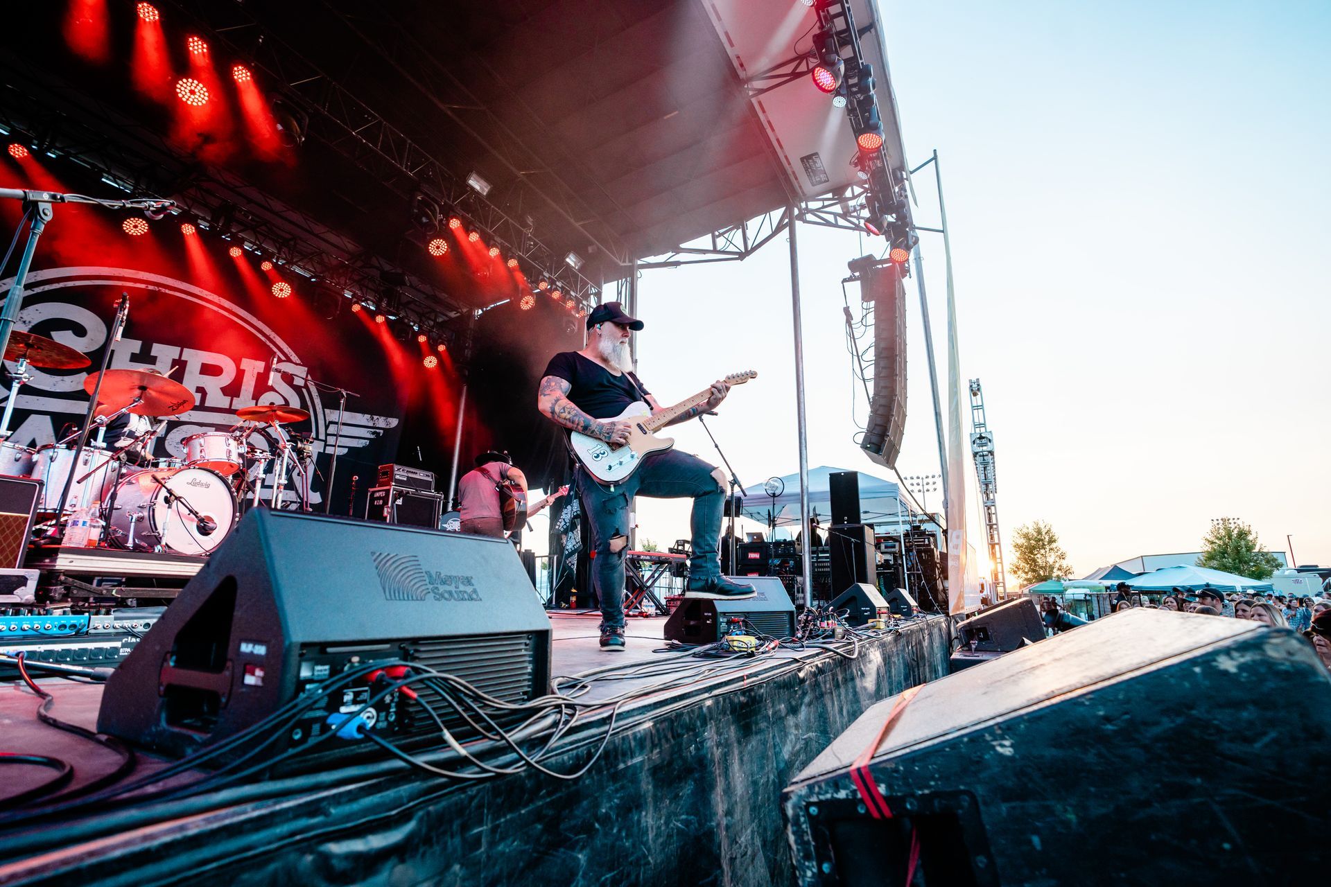 A man is playing a guitar on a stage at a concert.