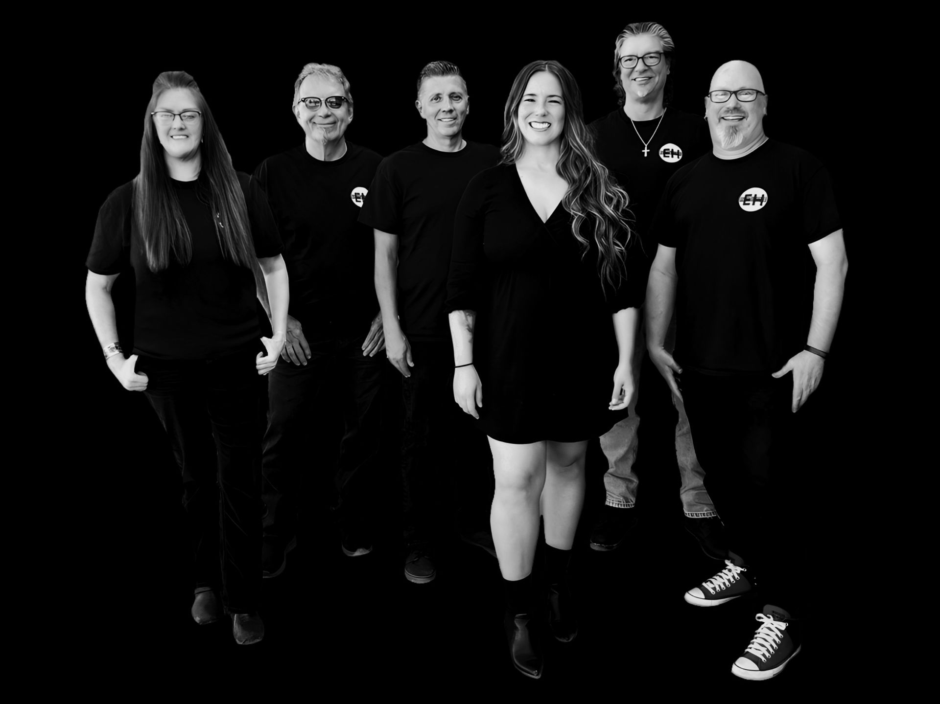 A grayscale band of six people posing against a black background.