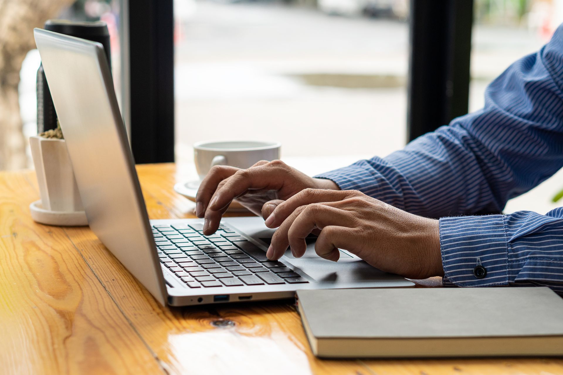 Man Typing on Laptop — Campbelltown, NSW — Gorman Jones Lawyers