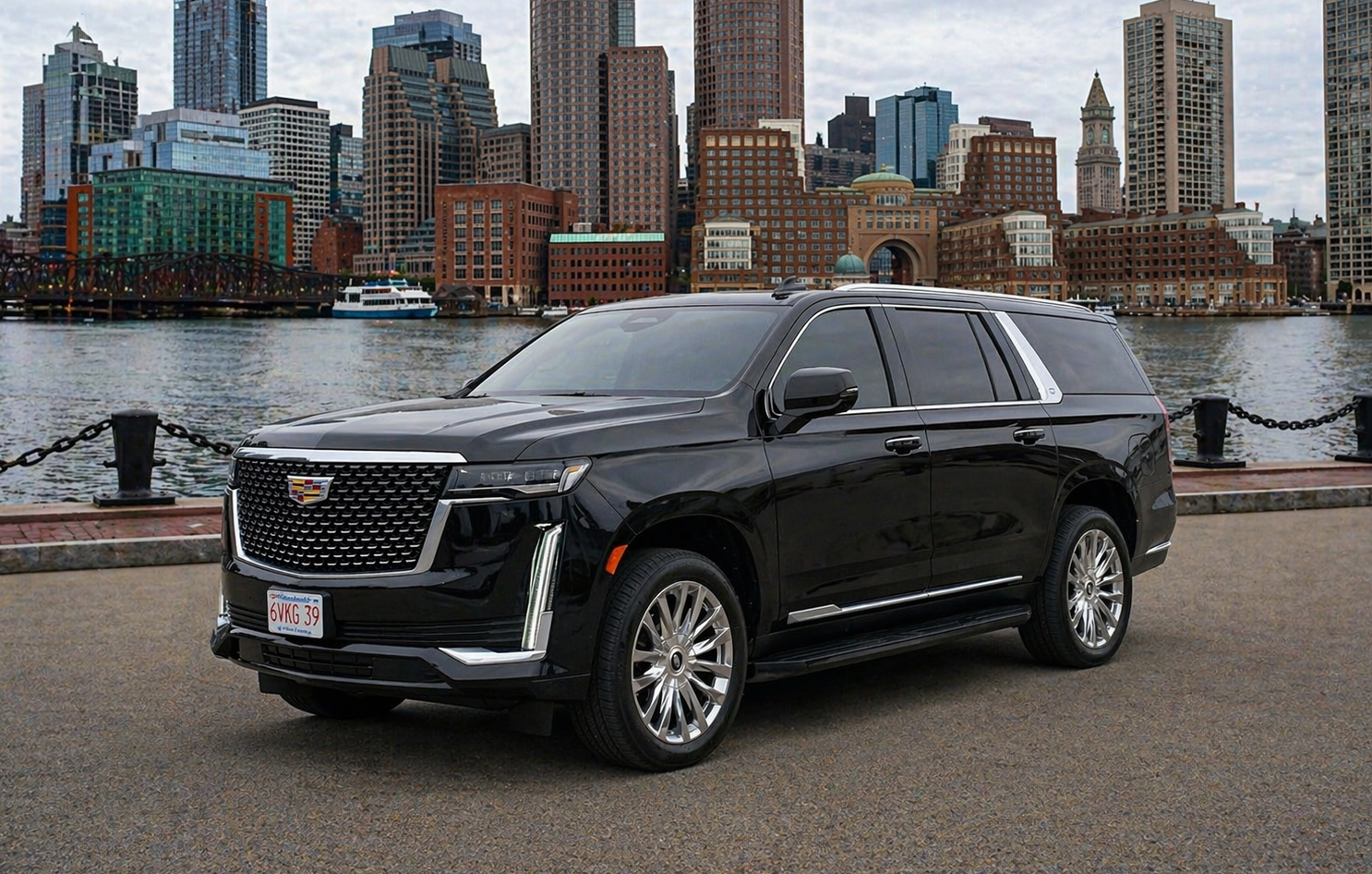 Black Cadillac SUV parked in urban area, city skyline in background.