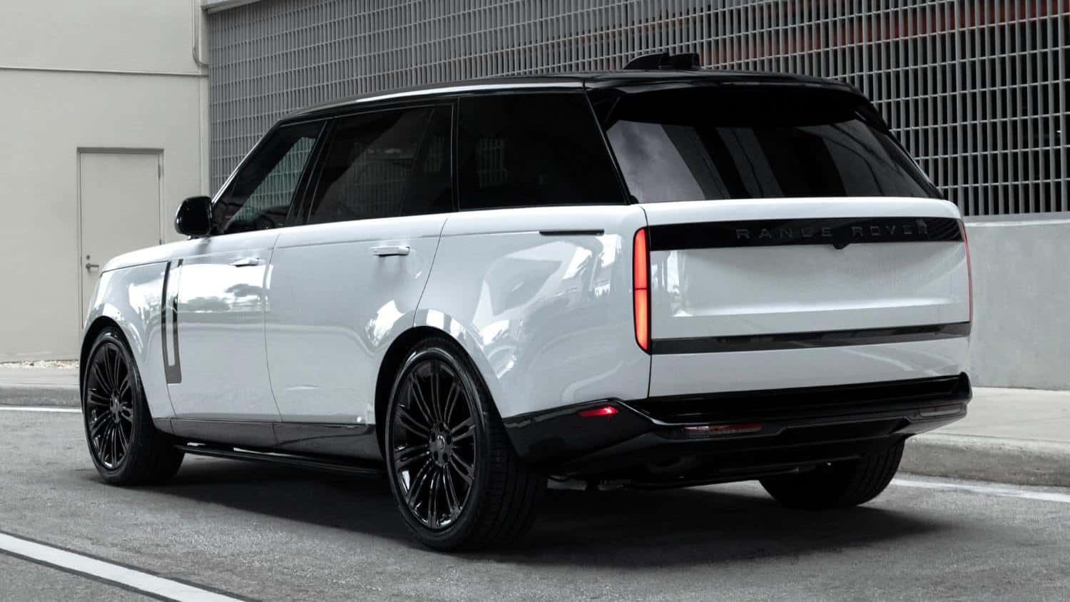 White and black Range Rover SUV parked on a city street.