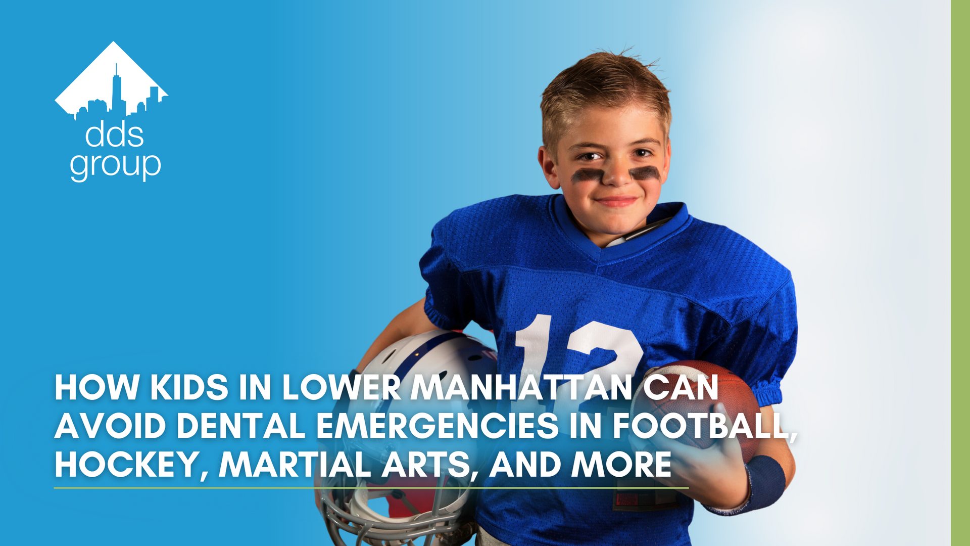 A young boy in a football uniform is holding a football.