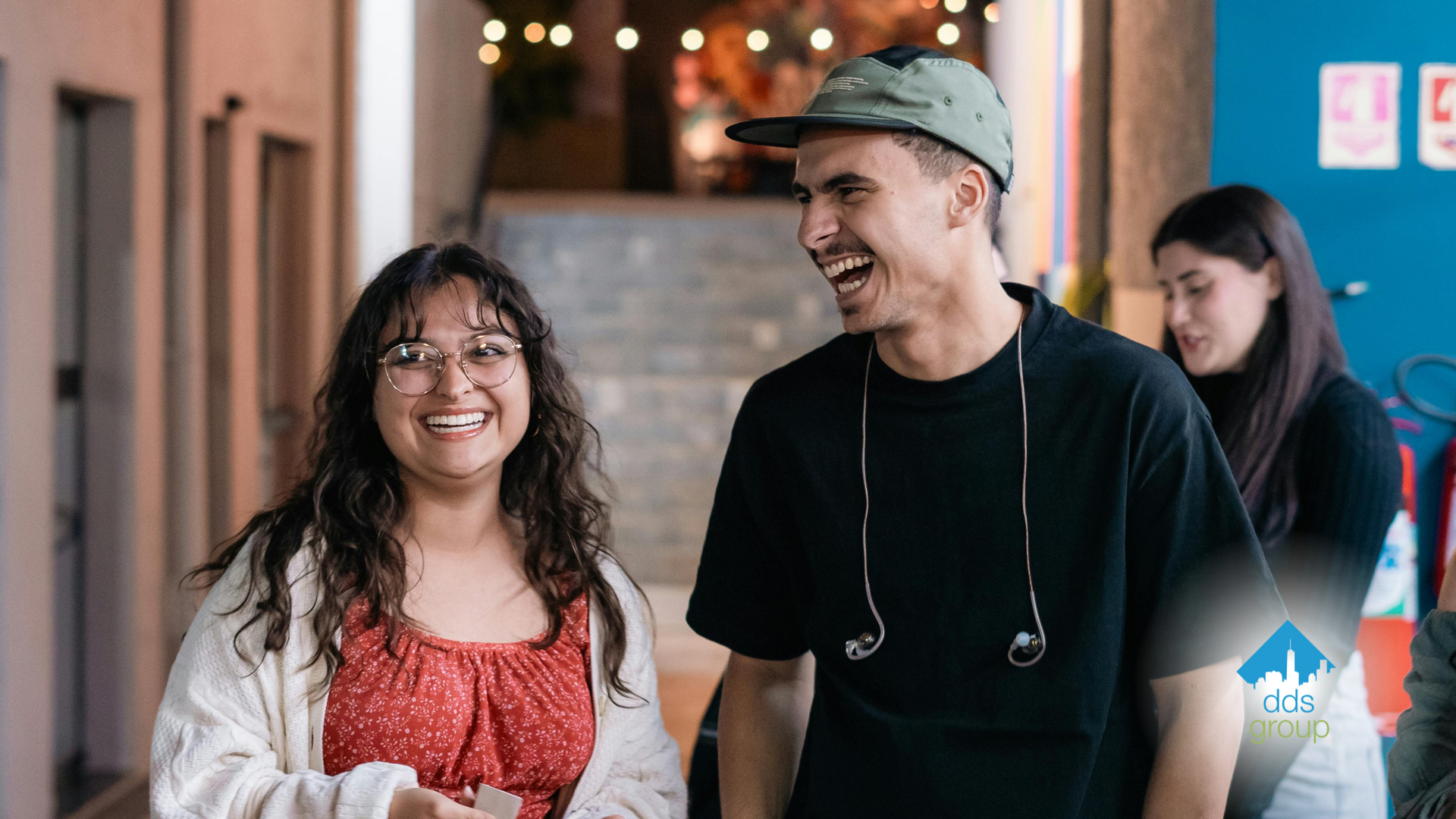 A man and a woman are standing next to each other and smiling.