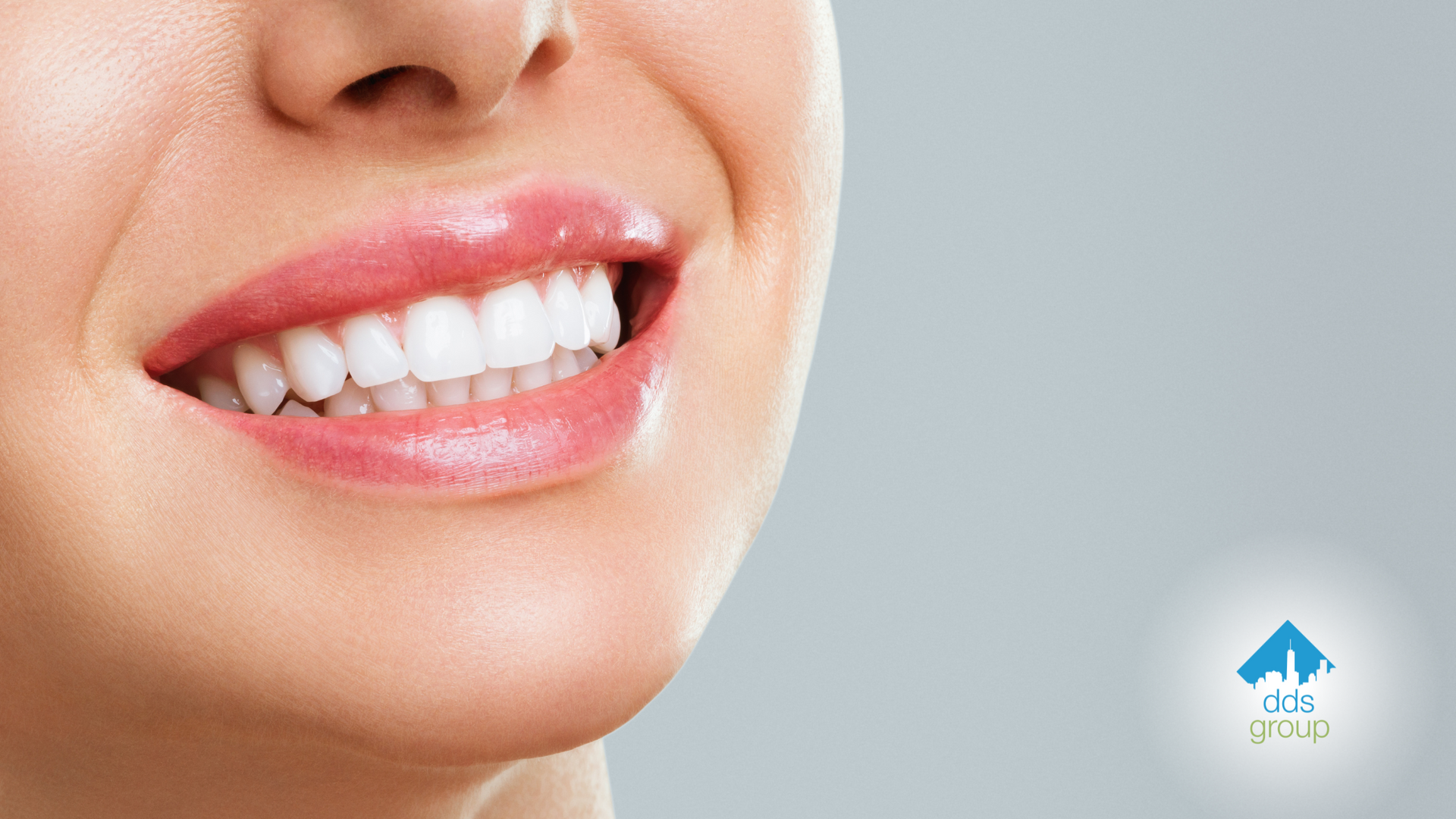 A close up of a woman 's smile with white teeth.