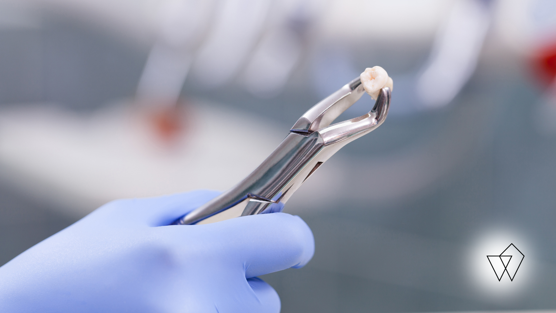 Gloved hand holding a dental tool with a clear aligner, in a clinical setting