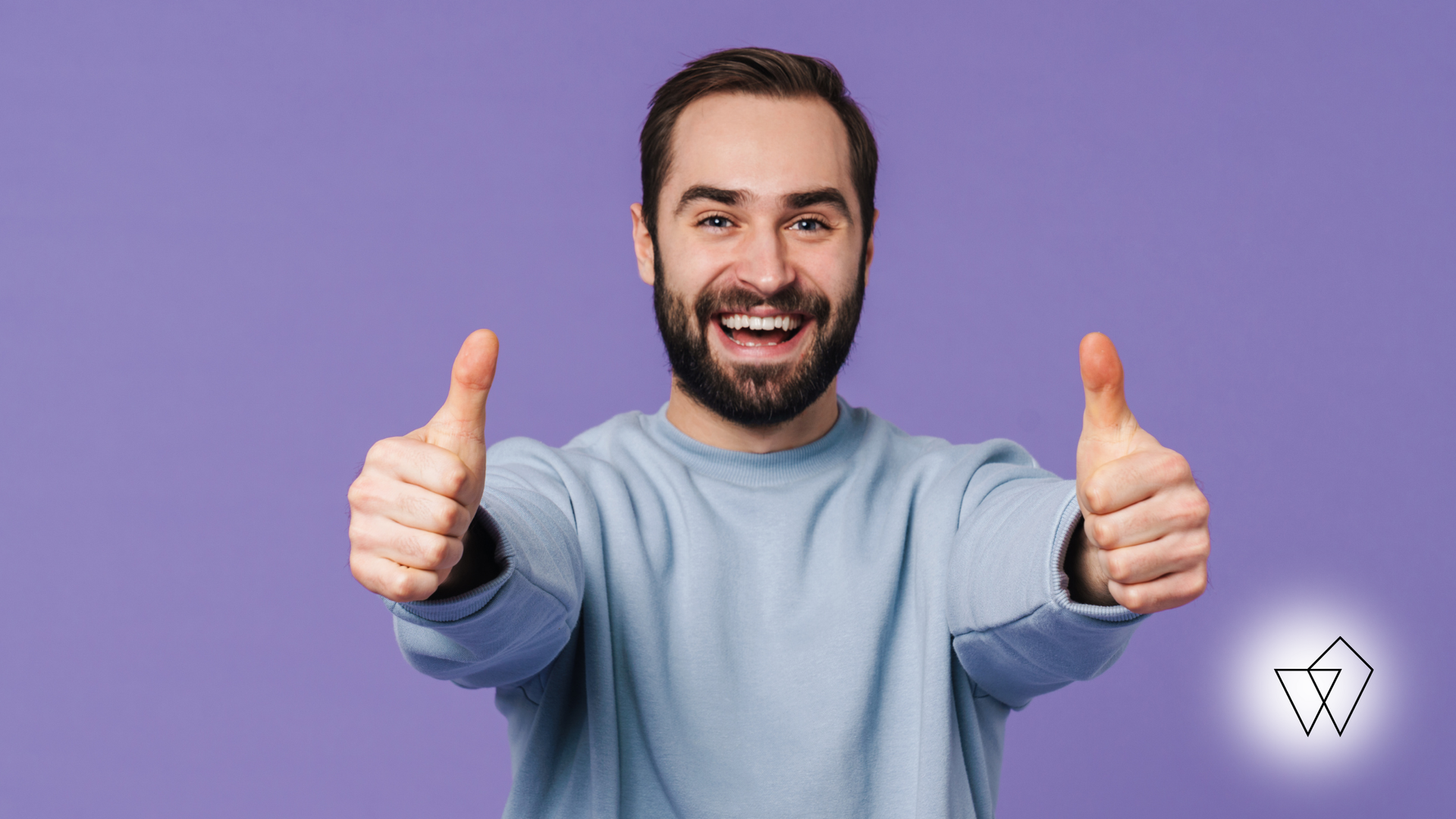 Man with beard giving double thumbs up, smiling broadly against a purple background.