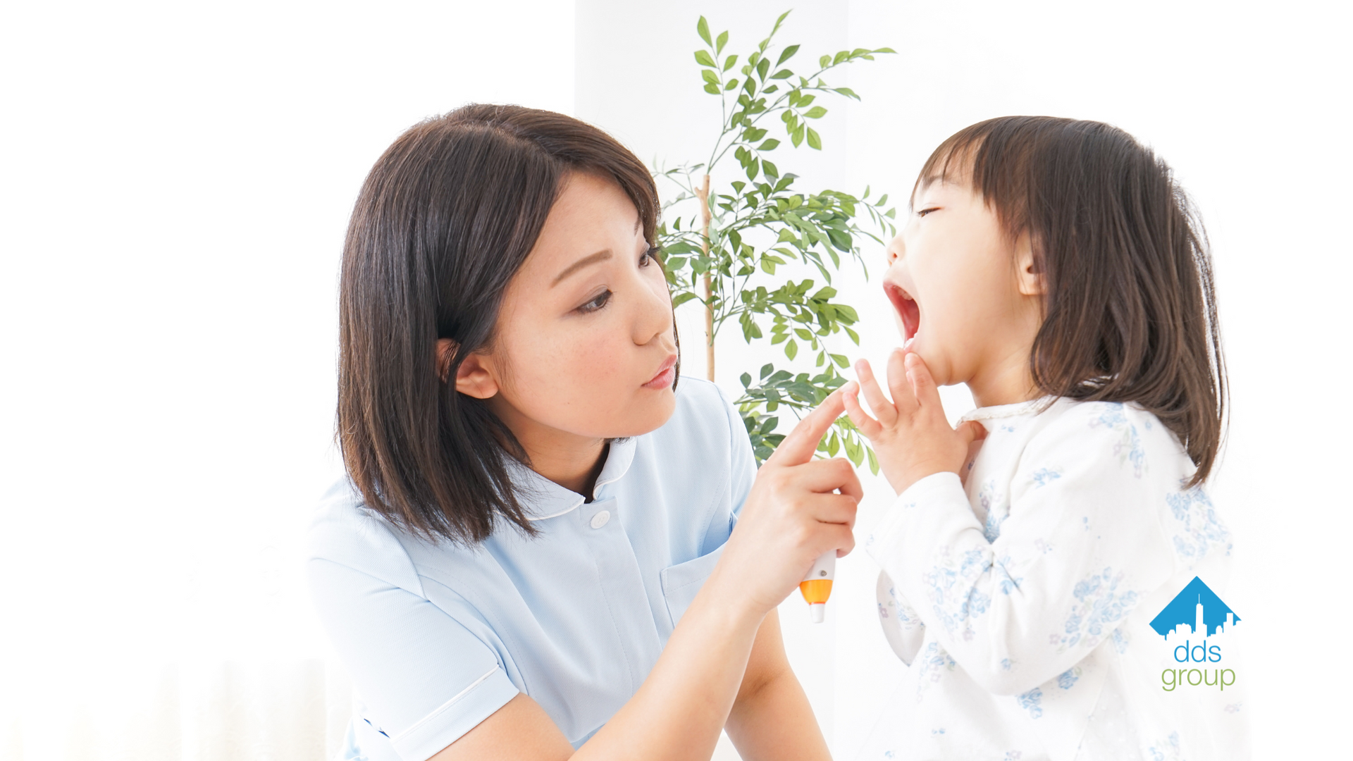 A woman is brushing a child 's teeth with a toothbrush.