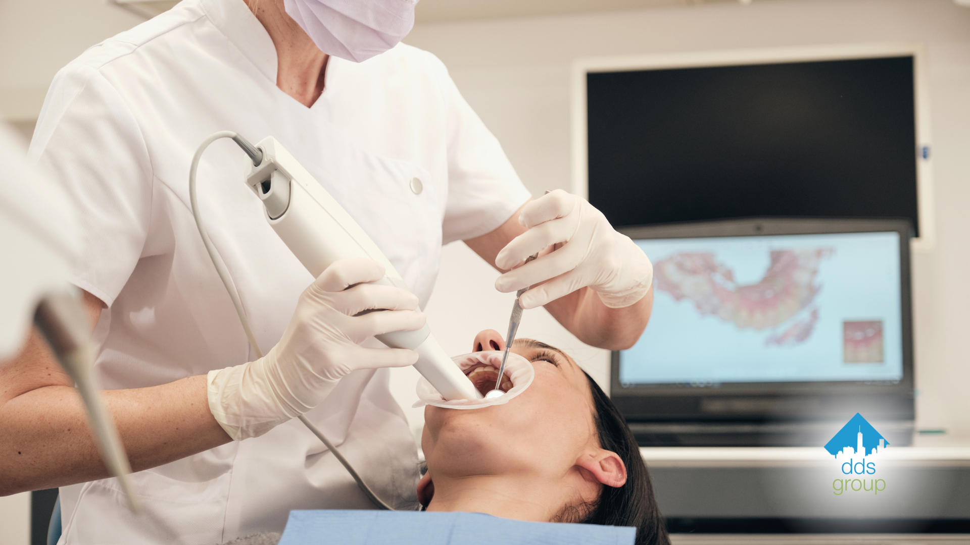 A dentist is examining a patient 's teeth in a dental office.