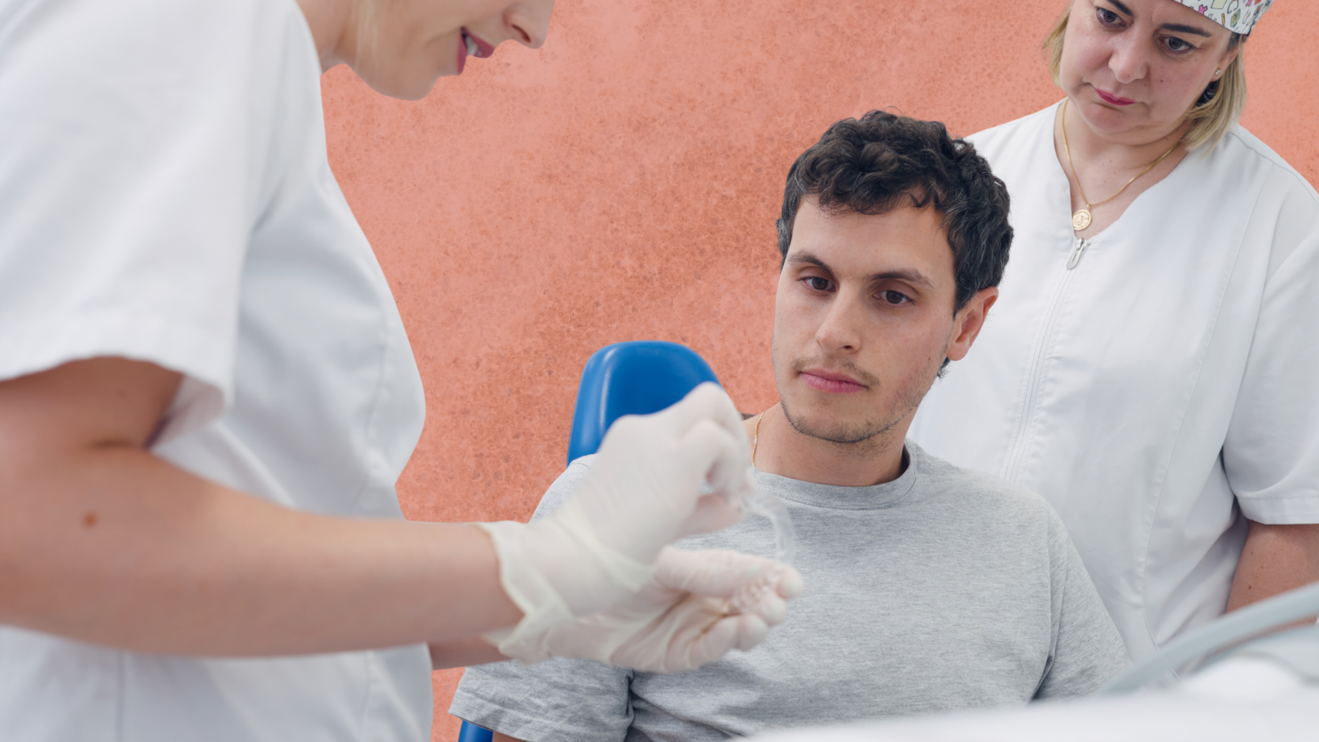 Dentist preparing injection for a patient in a dental office. Another assistant observes.