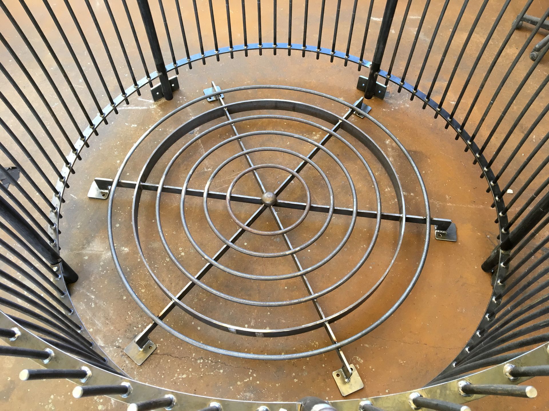 A metal circular object is surrounded by a metal fence — Keystone Engineering Sheet Metal Industries in Noosaville, QLD