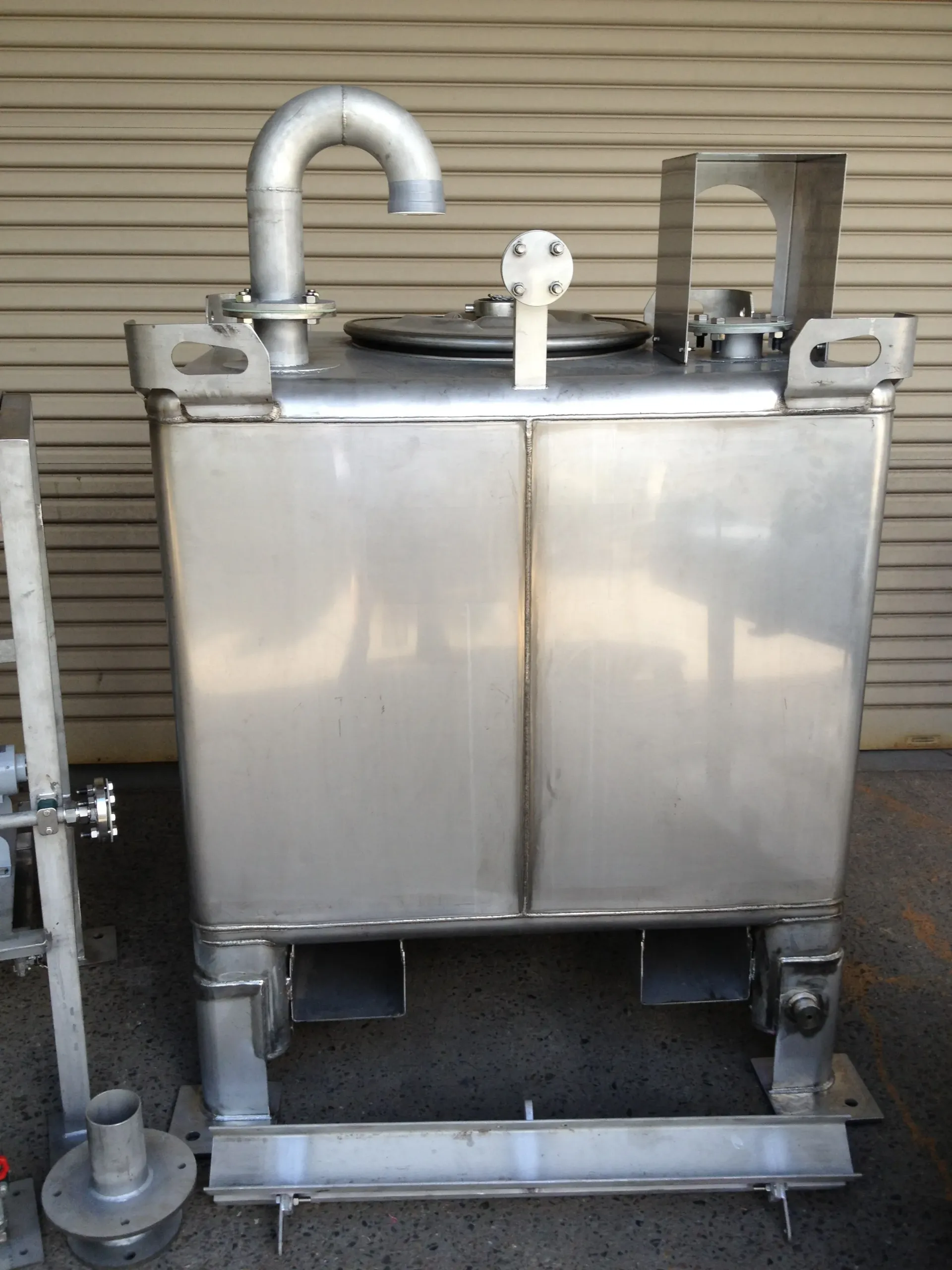 A stainless steel tank with a hose attached to it — Keystone Engineering Sheet Metal Industries in Noosaville, QLD