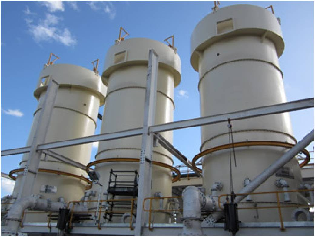 A row of white cylindrical tanks against a blue sky — Keystone Engineering Sheet Metal Industries in Noosaville, QLD
