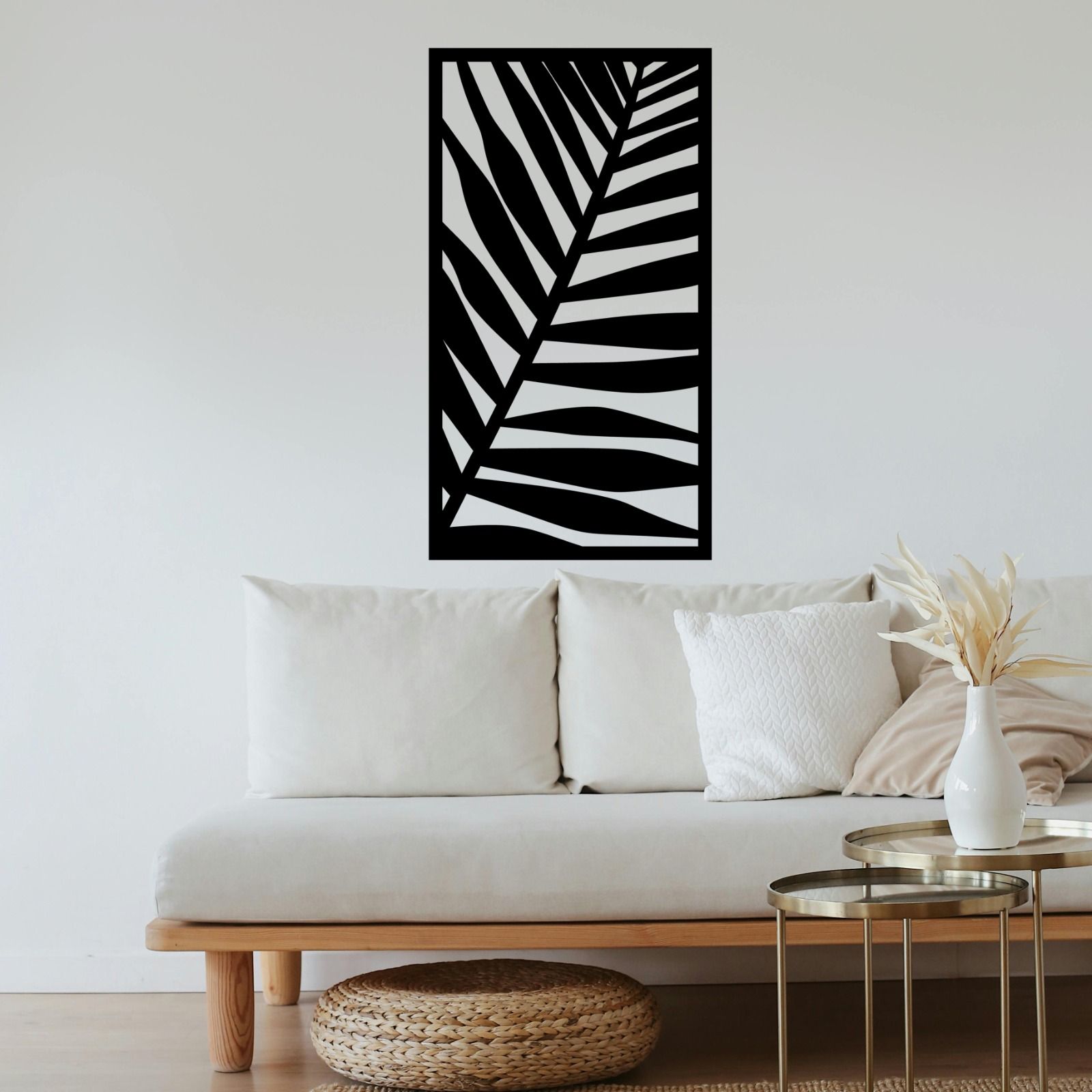 A living room with a white couch and a black leaf on the wall — Keystone Engineering Sheet Metal Industries in Noosaville, QLD