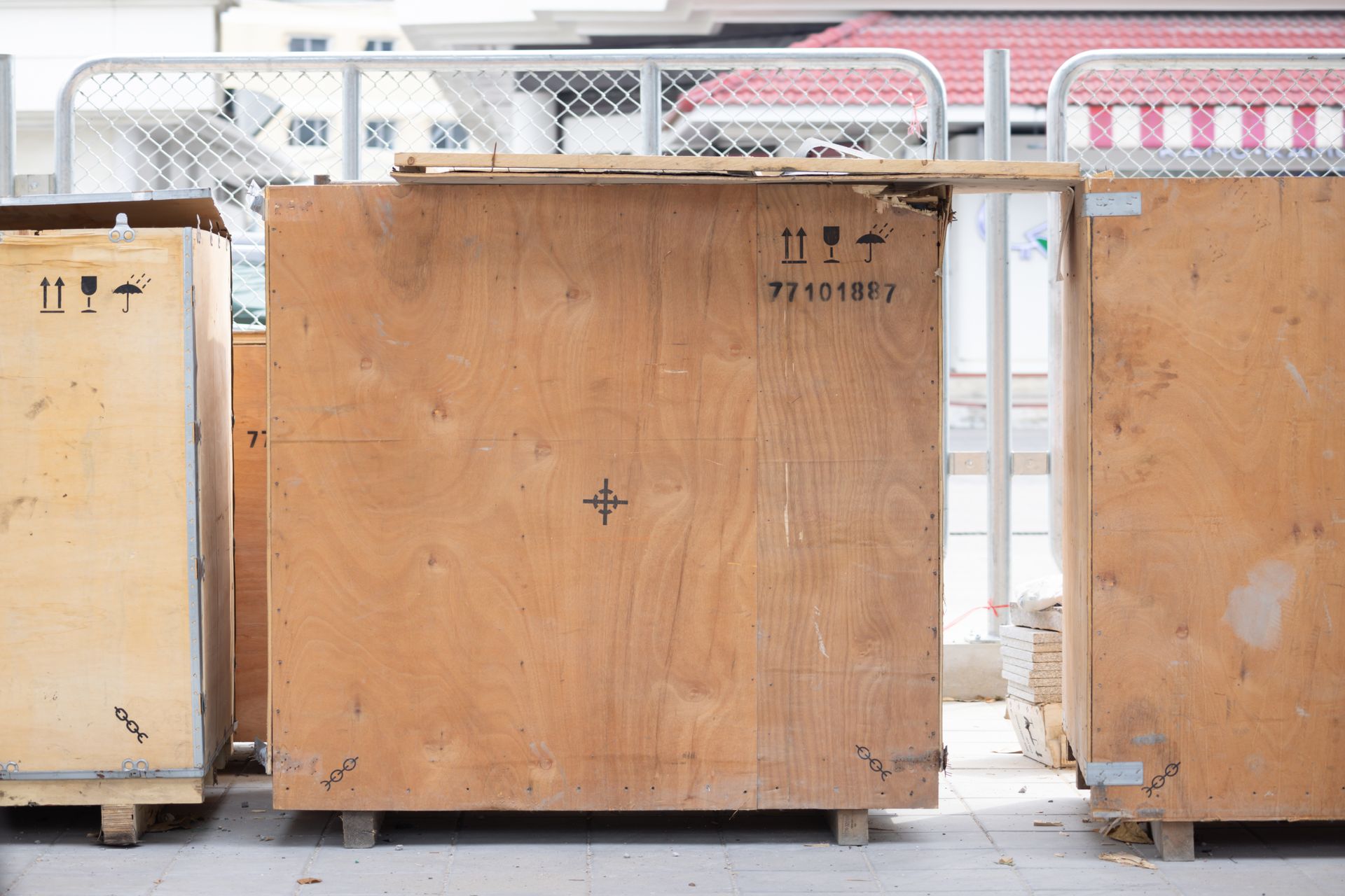 A row of wooden crates sitting next to each other on a sidewalk. — Keystone Engineering Sheet Metal Industries in Noosaville, QLD