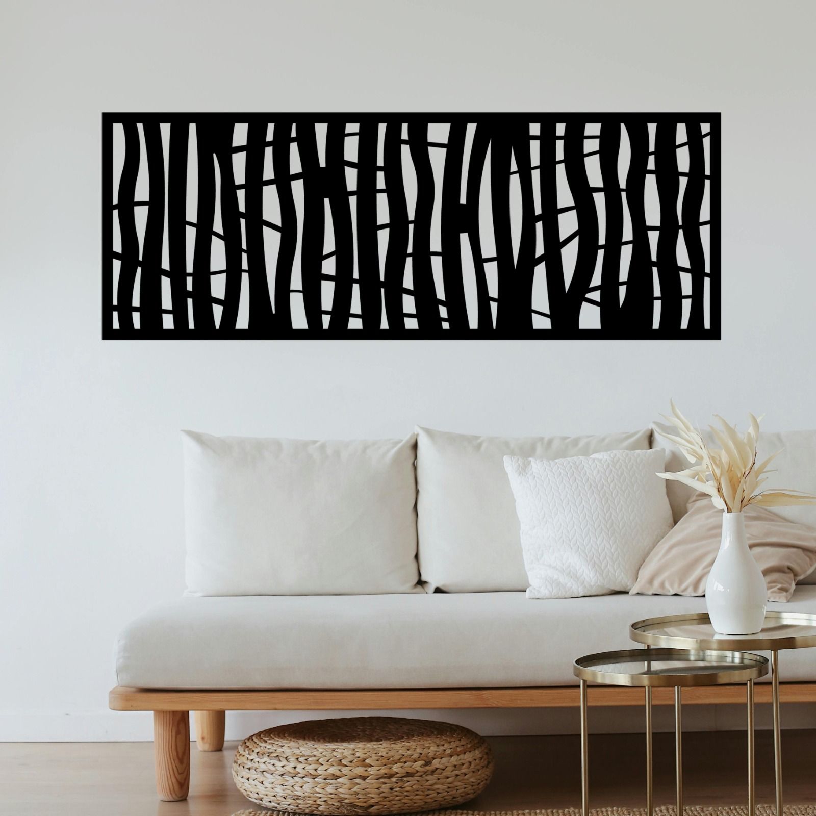 A living room with a couch and a painting on the wall — Keystone Engineering Sheet Metal Industries in Noosaville, QLD