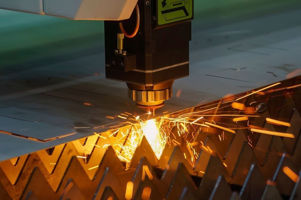 A Machine Is Cutting A Piece Of Metal With Sparks — Keystone Engineering Sheet Metal Industries in Noosaville, QLD