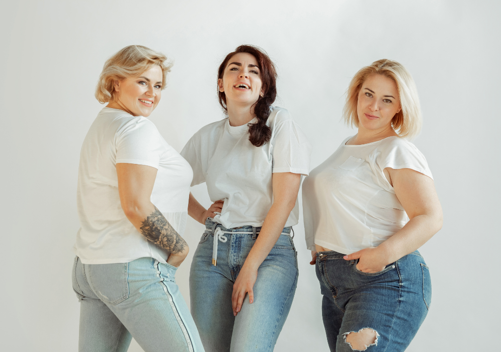 Three women posing in white T-Shirts and jeans