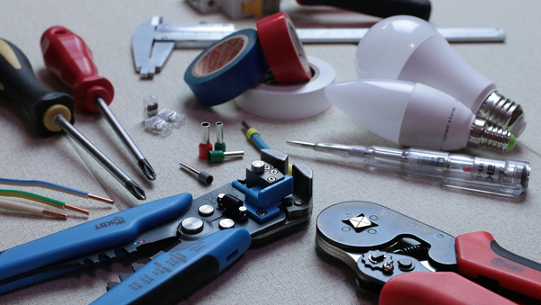 a table topped with a bunch of tools and a light bulb .