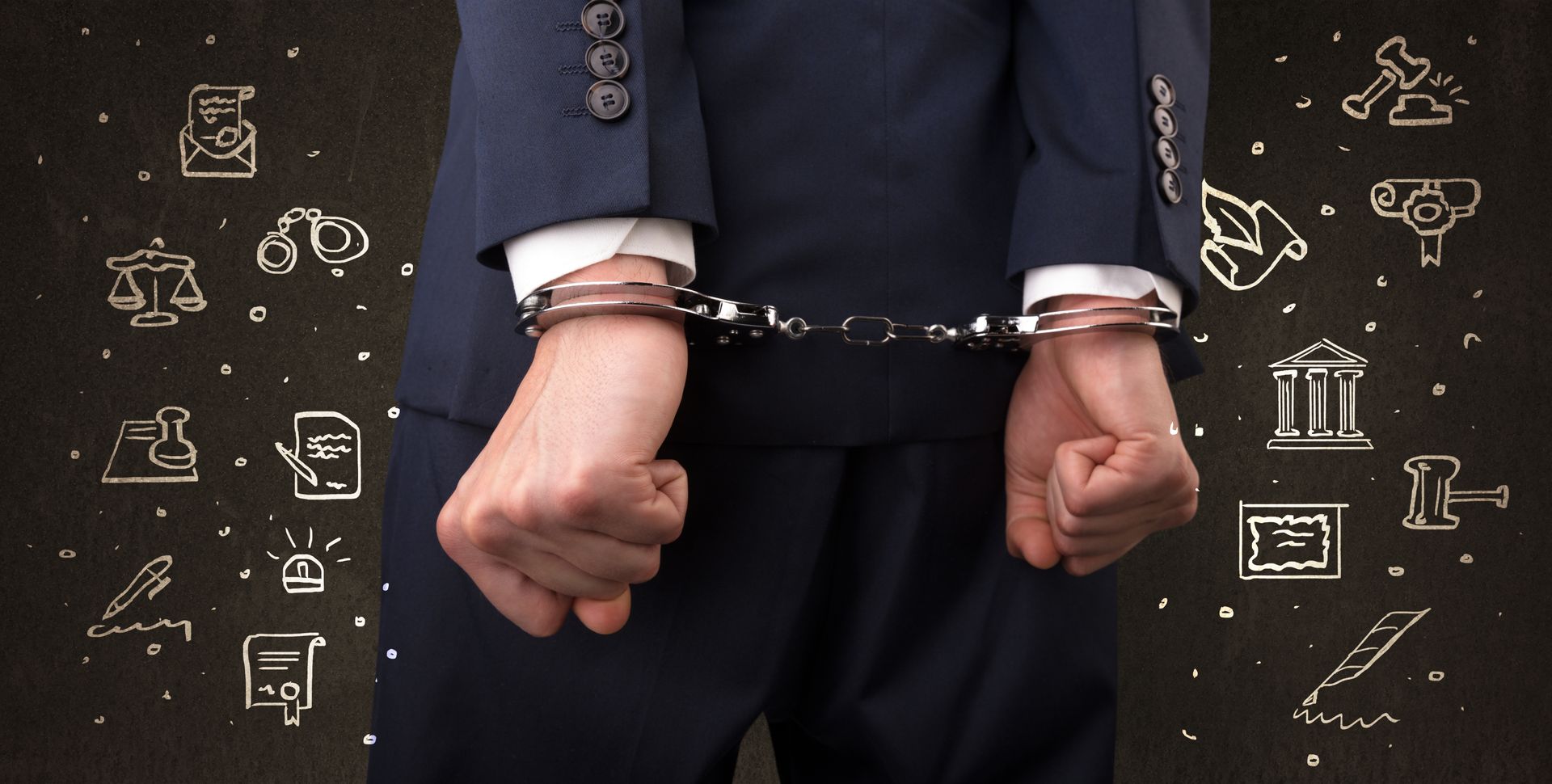 Man in suit with handcuffed wrists, surrounded by legal-themed doodles on a dark background.
