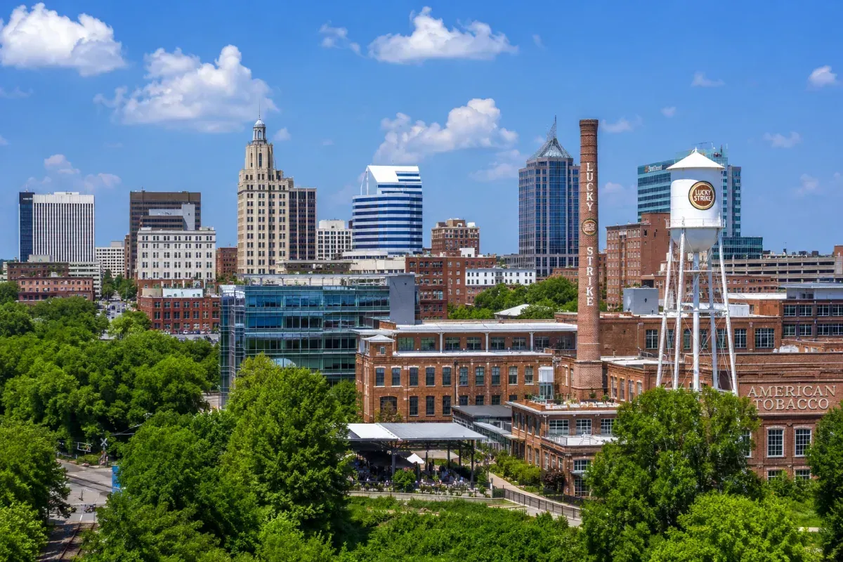 Downtown Durham, NC skyline in summer with the American Tobacco Campus and green trees