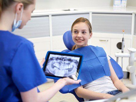 Dentist with Xray on Tablet - Dental Services in Clifton Park, NY