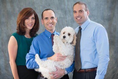 People Holding Puppy - Dentist in Clifton Park NY