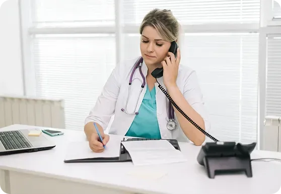 Dental Receptionist taking calls using deskphone Estate agent receptionist taking calls using phone