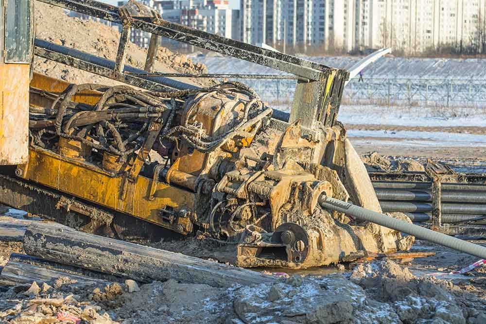 A machine is laying in the dirt on a construction site.