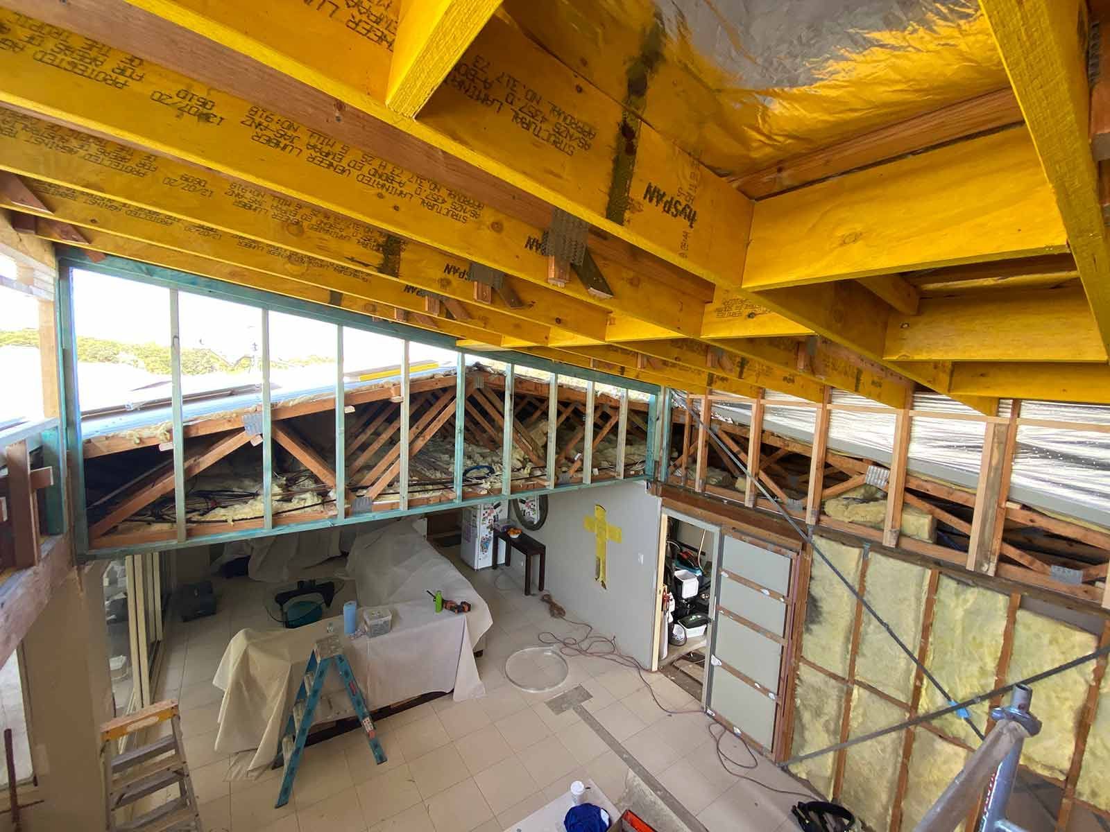 A Room Under Construction With A Wooden Ceiling And Stairs — B Smart Building & Design In Gerringong, NSW
