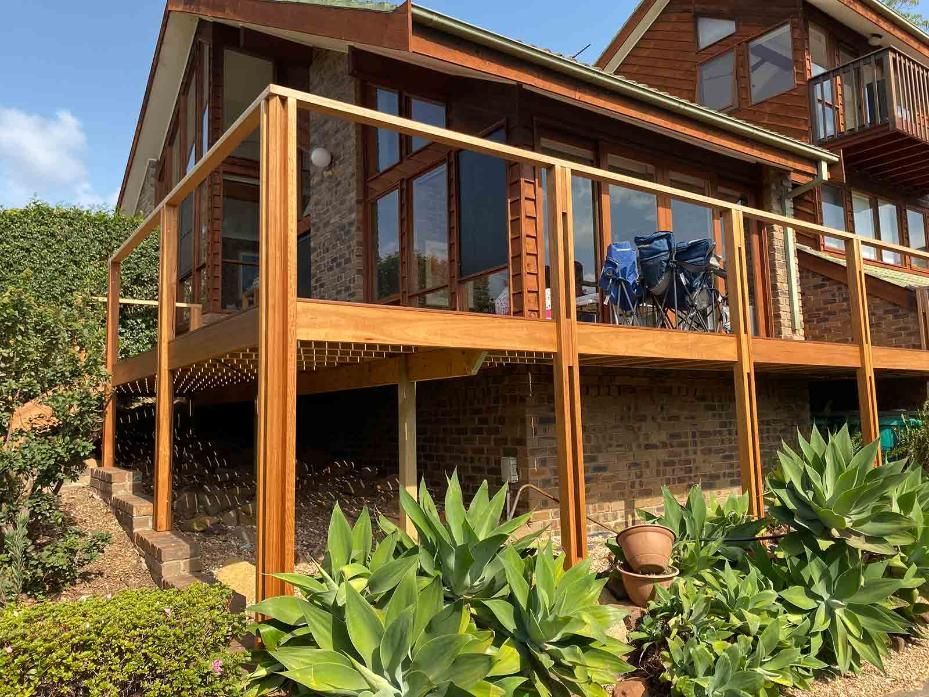 A Large House With A Wooden Deck And Stairs — B Smart Building & Design In Figtree, NSW