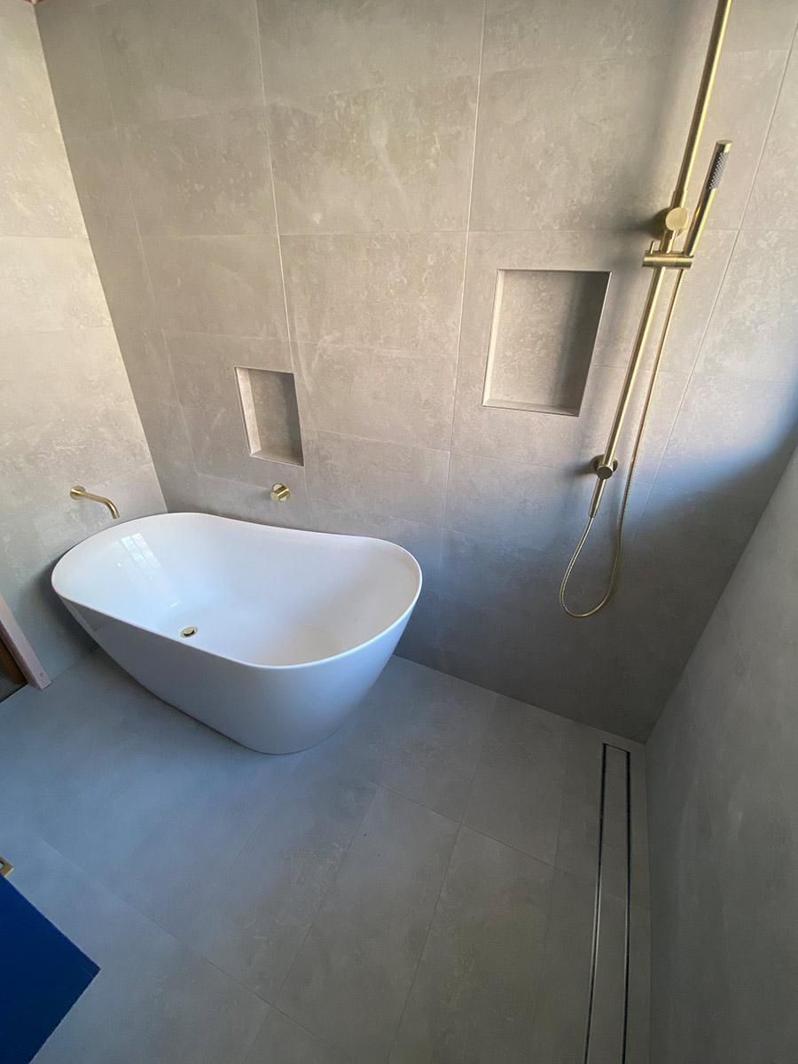 A Bathroom With A Bathtub And A Shower — B Smart Building & Design In Shellharbour, NSW