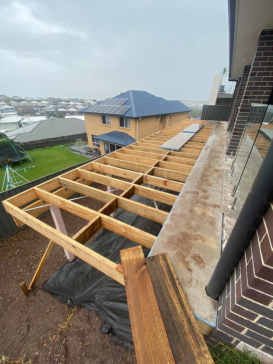 A Wooden Deck Is Being Built On The Roof Of A House — B Smart Building & Design In Gerringong, NSW