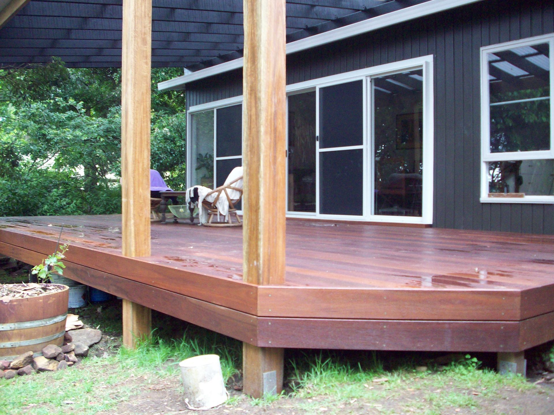 A Wooden Deck With A Sliding Door and Chair — B Smart Building & Design In Shellharbour, NSW